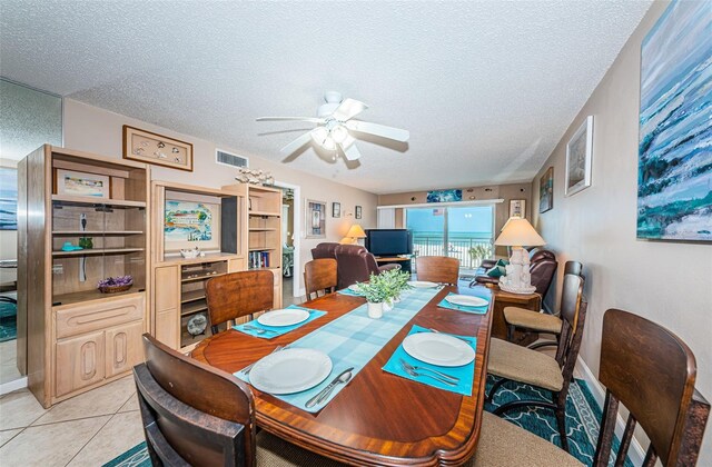 13000 Gulf Blvd Unit 109, Madeira Beach, FL 33708 - dining room with light tile patterned floors, visible vents, a textured ceiling, and a ceiling fan