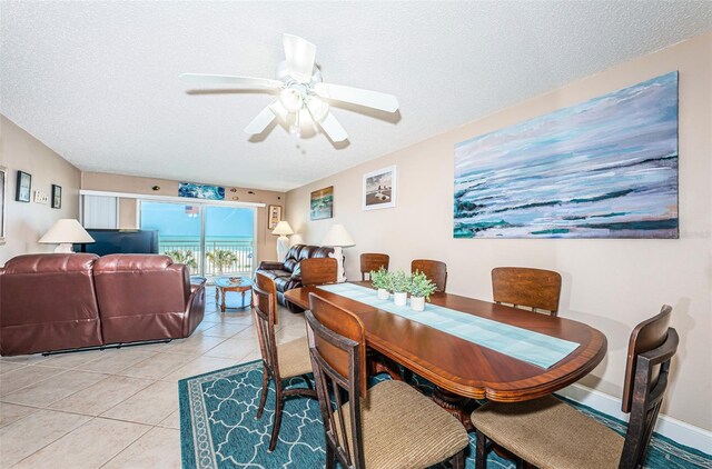 13000 Gulf Blvd Unit 109, Madeira Beach, FL 33708 - dining space with baseboards, light tile patterned floors, a textured ceiling, and a ceiling fan