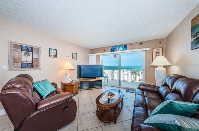 13000 Gulf Blvd Unit 109, Madeira Beach, FL 33708 - tiled living room featuring a textured ceiling