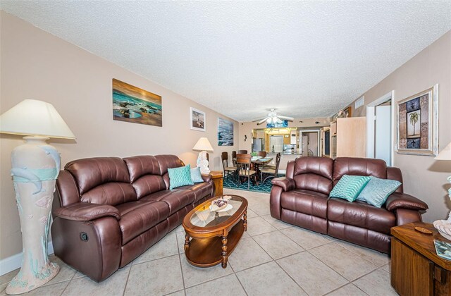 13000 Gulf Blvd Unit 109, Madeira Beach, FL 33708 - living room with a textured ceiling and light tile patterned flooring