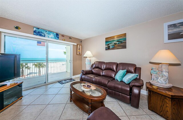 13000 Gulf Blvd Unit 109, Madeira Beach, FL 33708 - tiled living area with a textured ceiling and baseboards