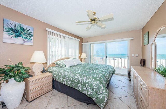 13000 Gulf Blvd Unit 109, Madeira Beach, FL 33708 - bedroom featuring access to outside, multiple windows, a textured ceiling, and light tile patterned flooring