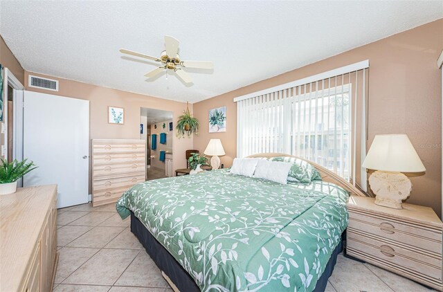 13000 Gulf Blvd Unit 109, Madeira Beach, FL 33708 - bedroom with light tile patterned floors, visible vents, a textured ceiling, and ceiling fan