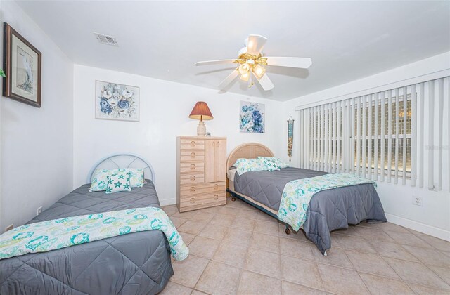 13000 Gulf Blvd Unit 109, Madeira Beach, FL 33708 - bedroom featuring visible vents, ceiling fan, baseboards, and light tile patterned floors