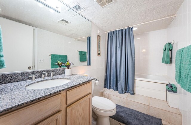 13000 Gulf Blvd Unit 109, Madeira Beach, FL 33708 - full bath with visible vents, tile walls, and a textured ceiling