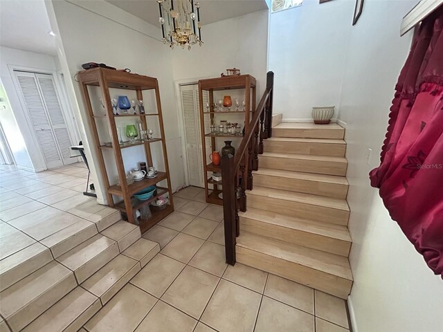 14633 Sassandra Dr, Odessa, FL 33556 - stairway featuring tile patterned floors and a notable chandelier
