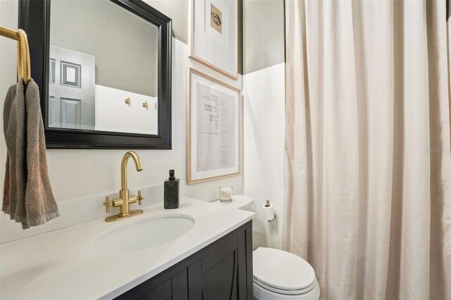 bathroom with toilet and vanity