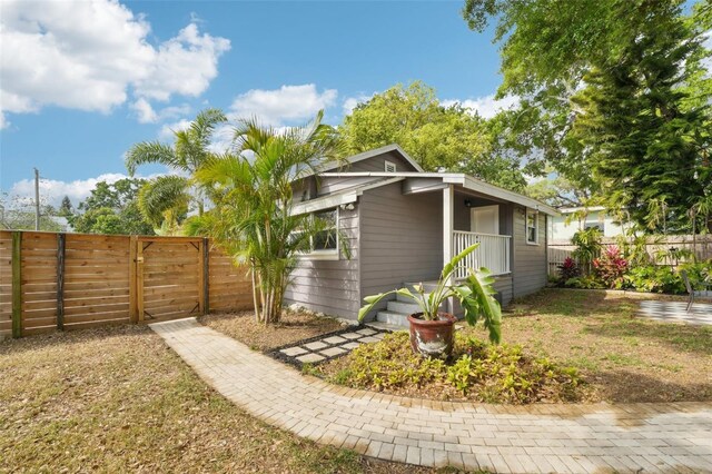 view of side of home with a gate and fence