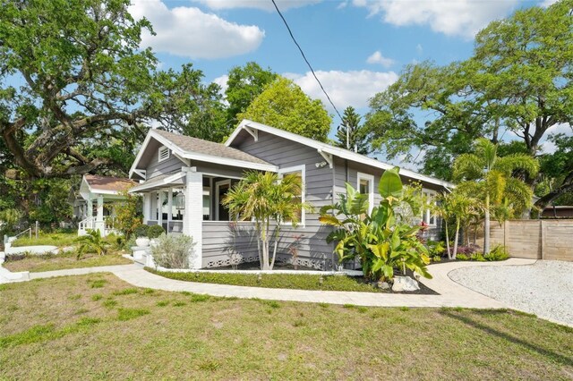 view of home's exterior featuring fence and a lawn
