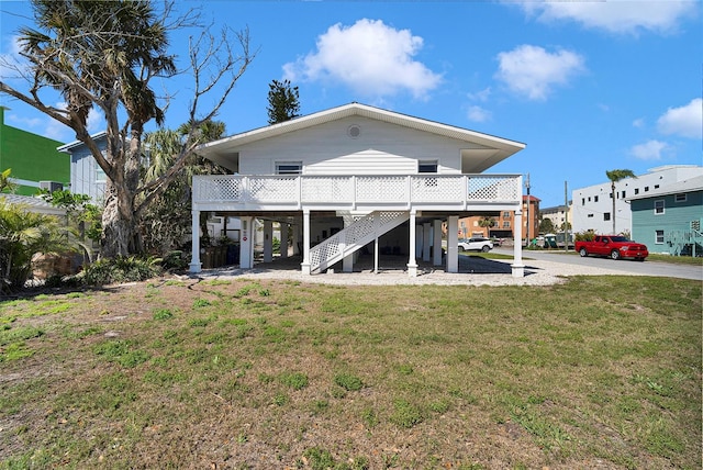 2116/2114 1st St, Indian Rocks Beach, FL 33785 - back of property featuring a carport, stairs, and a yard