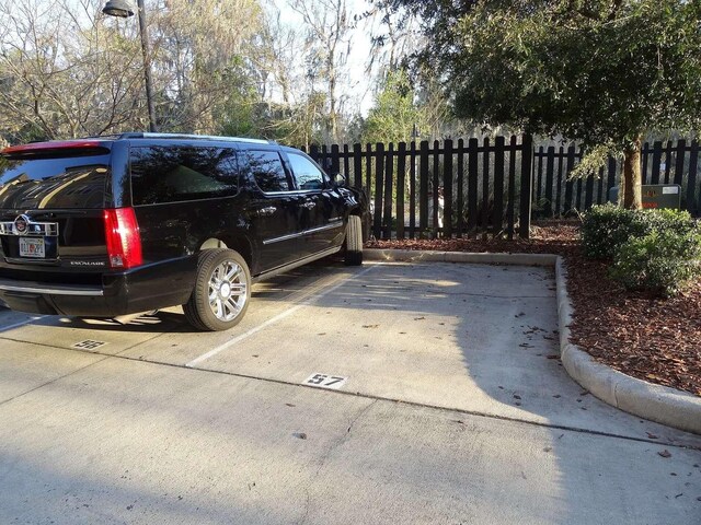 1185 SW 9th Rd Unit 107, Gainesville, FL 32601 - view of car parking with fence