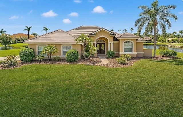6181 9th Avenue Cir NE, Bradenton, FL 34212 - view of front of property featuring a front yard, stucco siding, french doors, and a water view