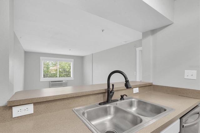 kitchen with dishwasher, light countertops, a sink, and a wall unit AC