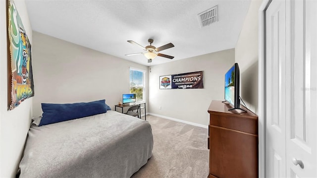 bedroom featuring light colored carpet, baseboards, a ceiling fan, and visible vents