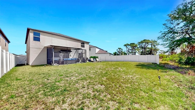 view of yard with a sunroom and a fenced backyard