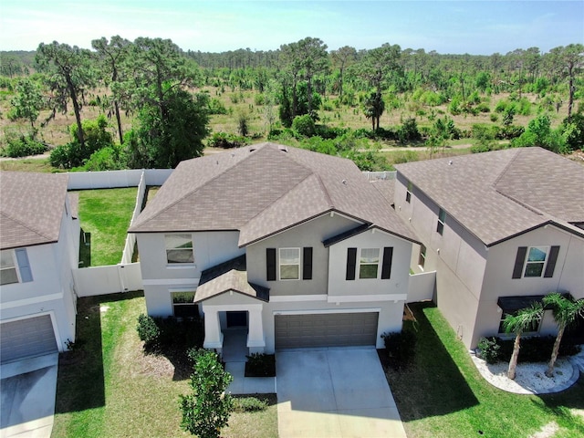 birds eye view of property featuring a view of trees