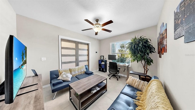 living room with ceiling fan and baseboards