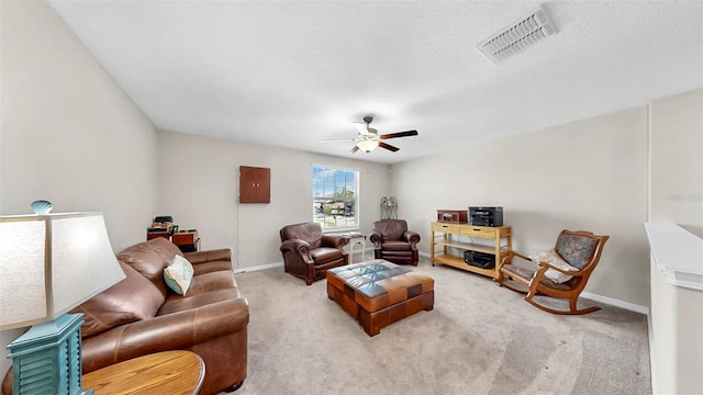 living room with baseboards, visible vents, ceiling fan, and light colored carpet