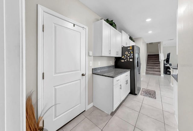kitchen featuring white cabinets, stainless steel fridge, recessed lighting, and light tile patterned floors