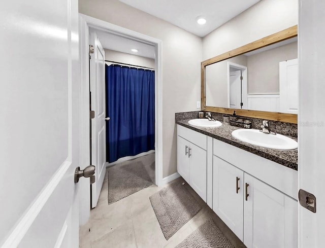 full bathroom featuring a sink, a shower with shower curtain, and double vanity