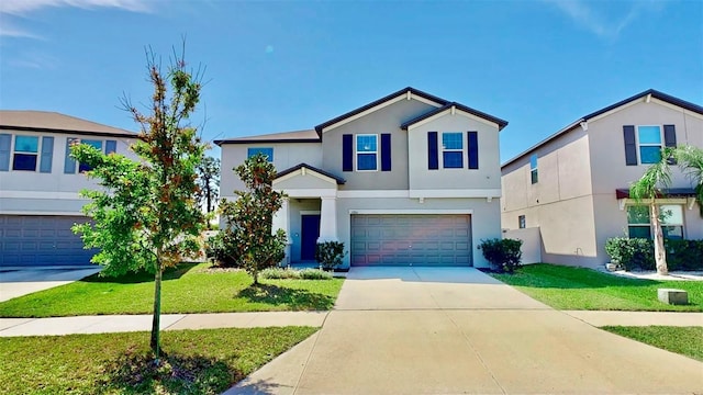 traditional-style house with stucco siding, concrete driveway, a front yard, and a garage