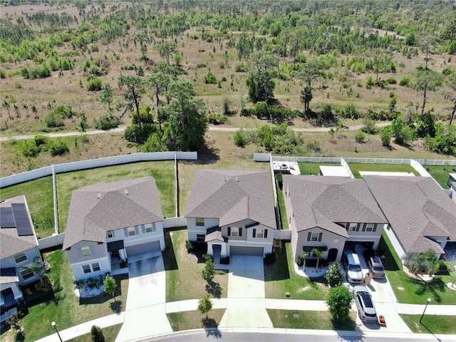 drone / aerial view featuring a view of trees and a residential view