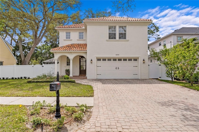 4310 W Sevilla St, Tampa, FL 33629 - mediterranean / spanish home featuring a tiled roof, a gate, decorative driveway, and a garage