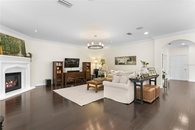4310 W Sevilla St, Tampa, FL 33629 - living room featuring a notable chandelier, dark wood finished floors, visible vents, arched walkways, and ornamental molding