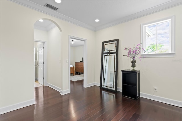4310 W Sevilla St, Tampa, FL 33629 - empty room with visible vents, crown molding, baseboards, wood finished floors, and arched walkways
