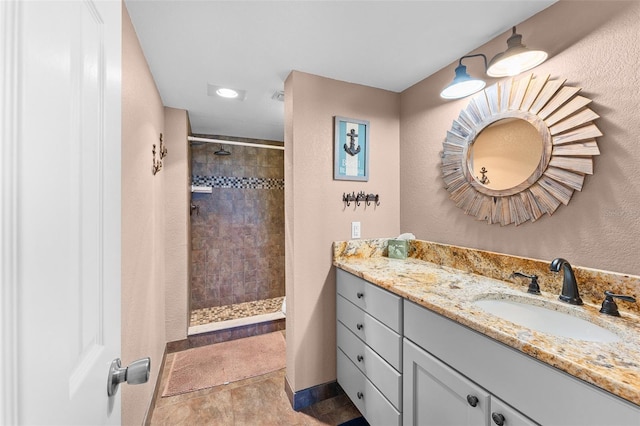 1901 Oyster Catcher Ln Unit 823, Clearwater, FL 33762 - bathroom featuring baseboards, tiled shower, and vanity
