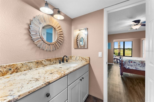 1901 Oyster Catcher Ln Unit 823, Clearwater, FL 33762 - bathroom featuring baseboards, wood finished floors, a textured wall, and vanity
