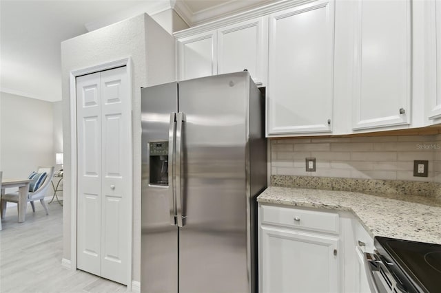 12379 Amica Loop, Venice, FL 34293 - kitchen with stainless steel appliances, ornamental molding, backsplash, white cabinets, and light stone countertops