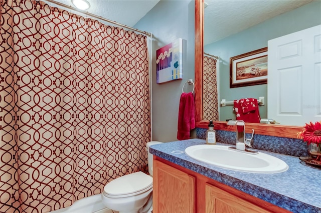 bathroom featuring toilet, vanity, and a textured ceiling