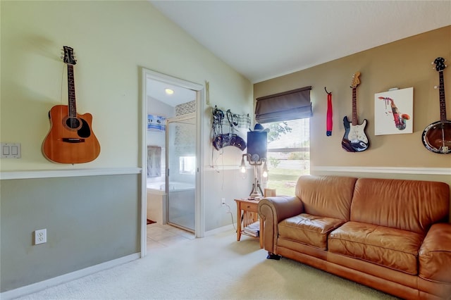 carpeted living area featuring baseboards and lofted ceiling