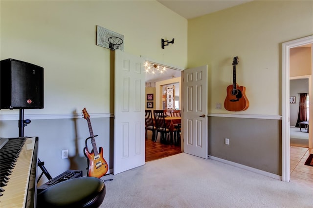 workout room with carpet flooring and a high ceiling