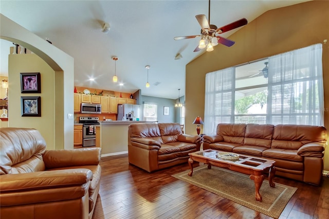 living area featuring dark wood-style floors, high vaulted ceiling, arched walkways, and a ceiling fan