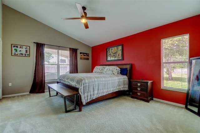 bedroom featuring baseboards, vaulted ceiling, carpet, and a ceiling fan