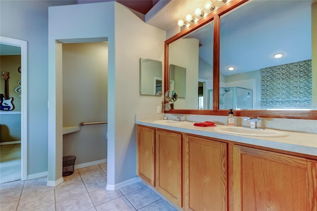 full bath featuring tile patterned flooring, a sink, a stall shower, and double vanity