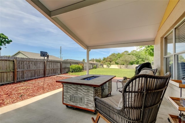 view of patio / terrace with an outdoor fire pit and a fenced backyard