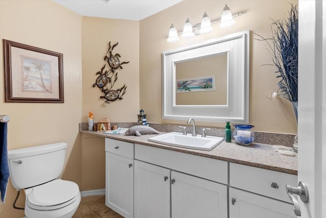 half bathroom with toilet, vanity, and tile patterned flooring