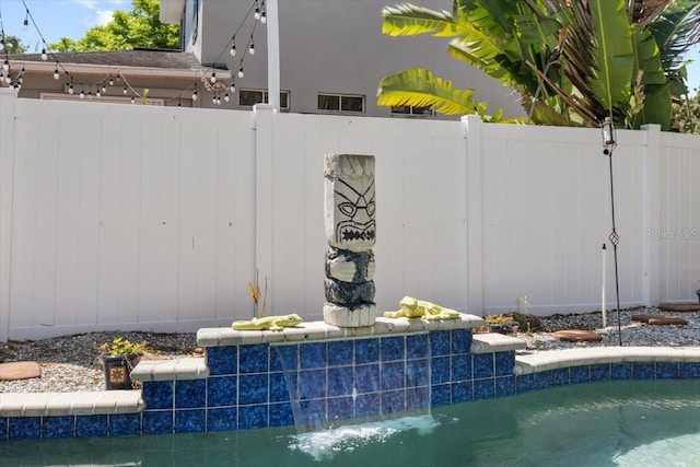 view of pool with fence