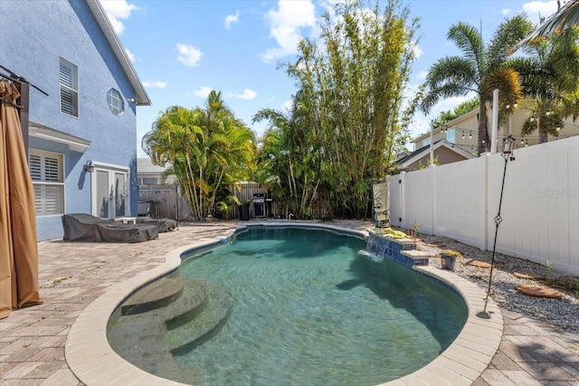view of swimming pool featuring a fenced backyard, a patio, and a fenced in pool