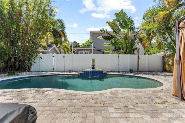 view of swimming pool featuring a fenced backyard, a gate, and a patio area