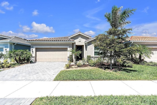 20647 Ovid Ln, Venice, FL 34293 - single story home with a tiled roof, stucco siding, decorative driveway, and a garage