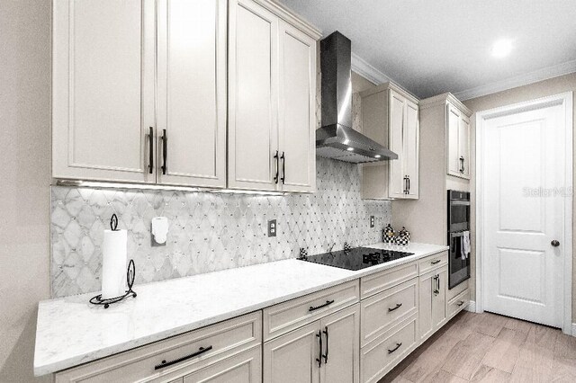 20647 Ovid Ln, Venice, FL 34293 - kitchen featuring black appliances, wall chimney range hood, crown molding, and tasteful backsplash