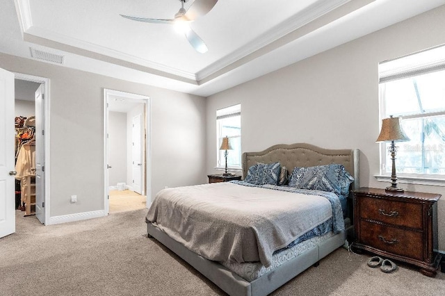 20647 Ovid Ln, Venice, FL 34293 - bedroom with a walk in closet, a tray ceiling, baseboards, visible vents, and light carpet
