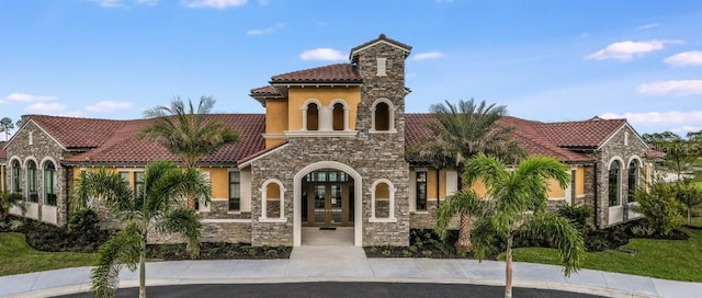 20647 Ovid Ln, Venice, FL 34293 - view of front of home featuring stone siding, a tile roof, french doors, and stucco siding
