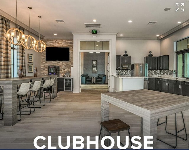 20647 Ovid Ln, Venice, FL 34293 - kitchen with visible vents, wine cooler, a chandelier, and crown molding