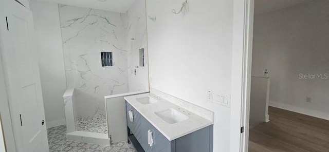 745 31st Ave N, Saint Petersburg, FL 33704 - full bath with a marble finish shower, double vanity, and wood finished floors
