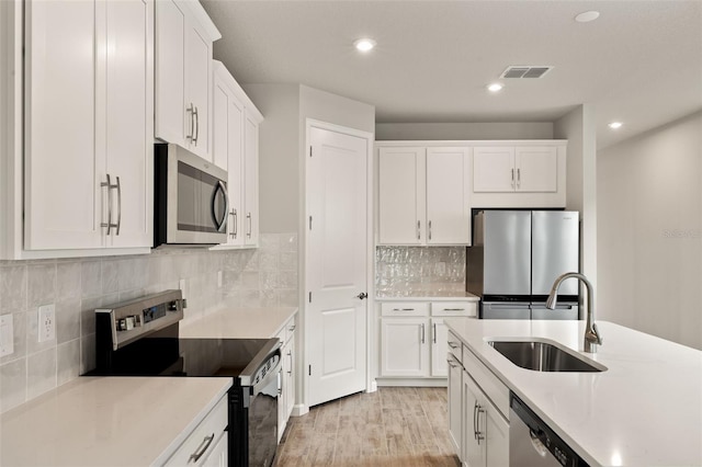 17800 Solstice Ave, Venice, FL 34293 - kitchen featuring a sink, visible vents, white cabinets, and appliances with stainless steel finishes